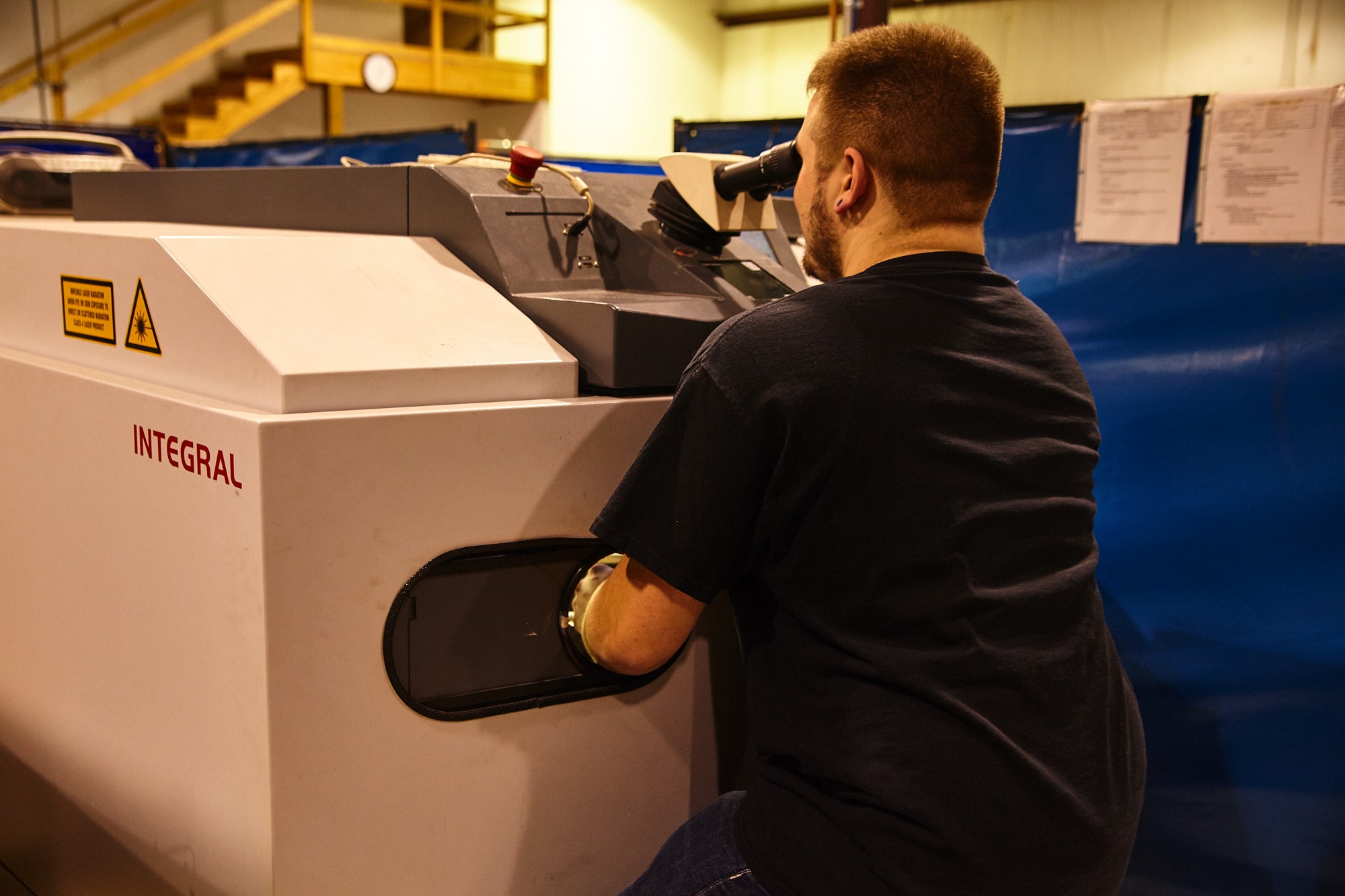 Microtech's employee working on a welding machine for the medical field