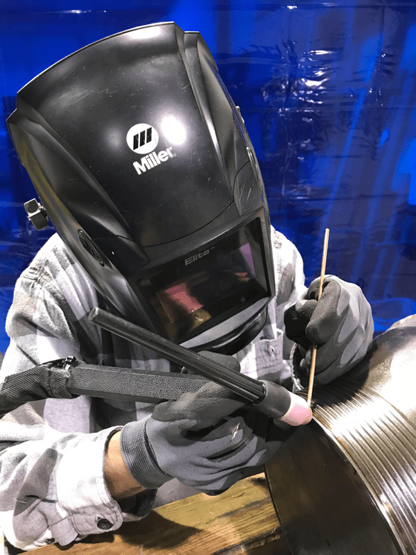 A Microtech's welder welding a metal component