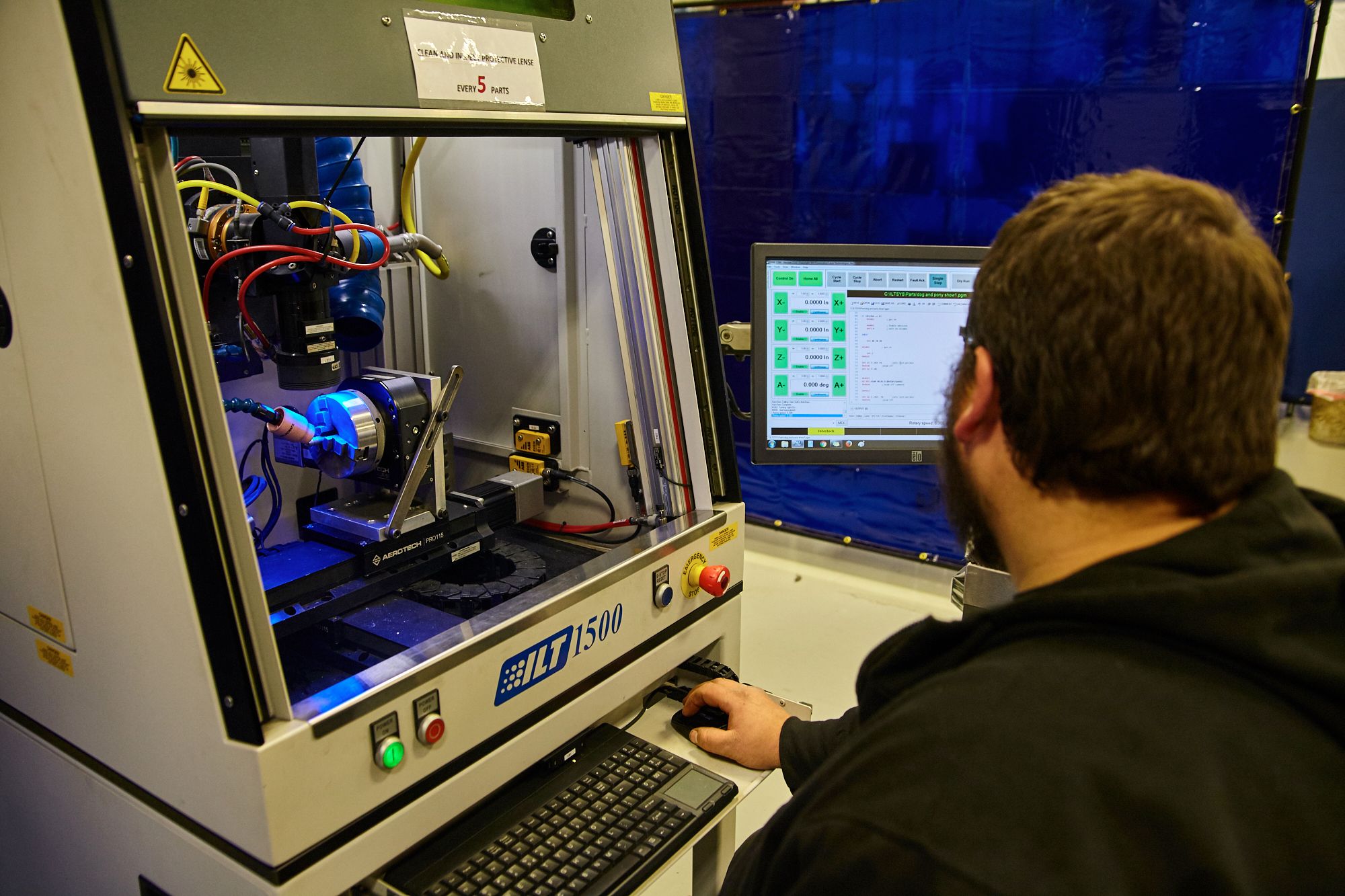 Employee uses computer to operate laser beam welder