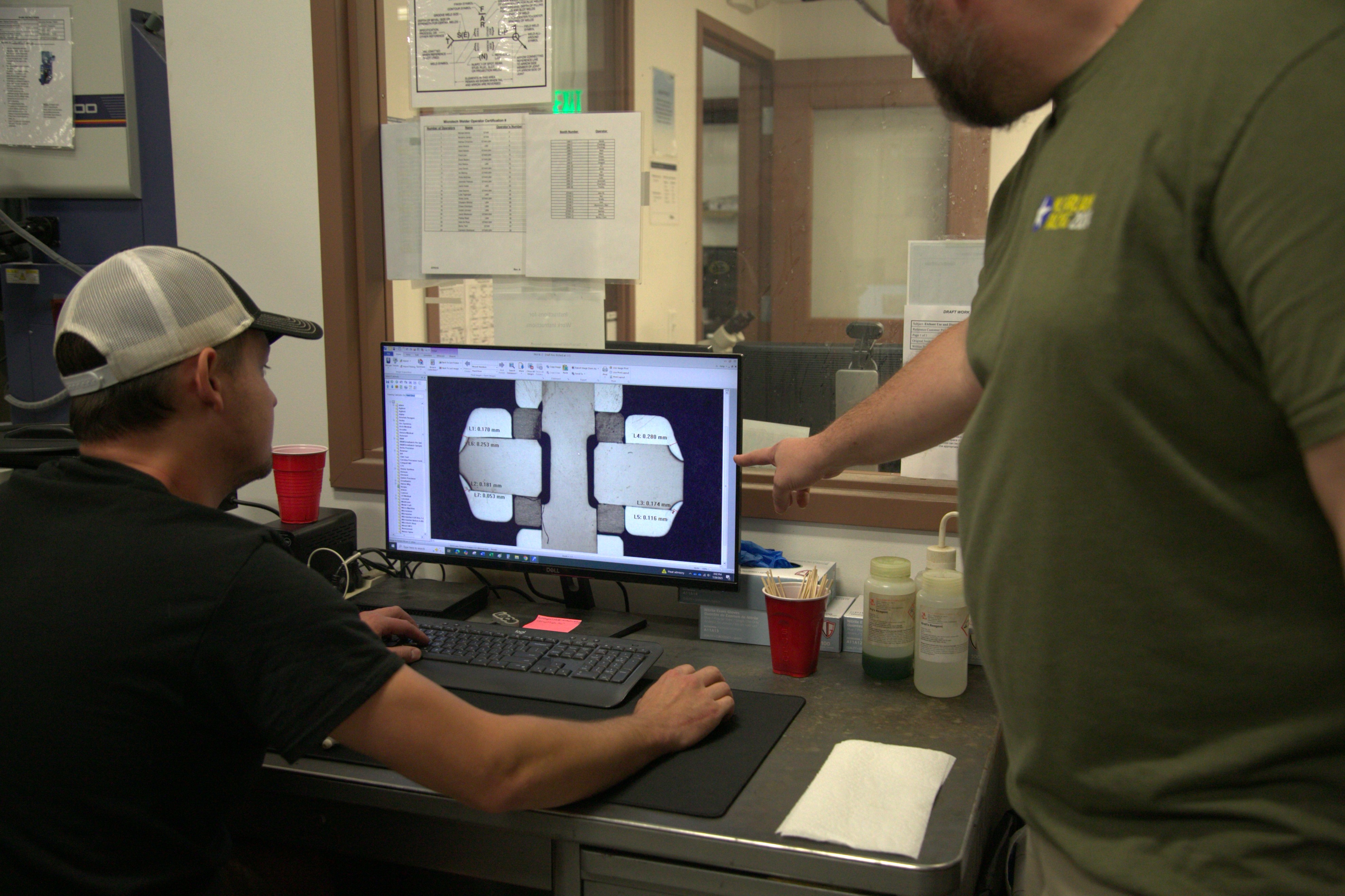 Two Microtech's employees working together at the computer
